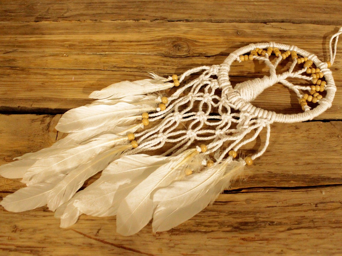1. White Tree of Life dreamcatcher with feathers displayed on wooden surface