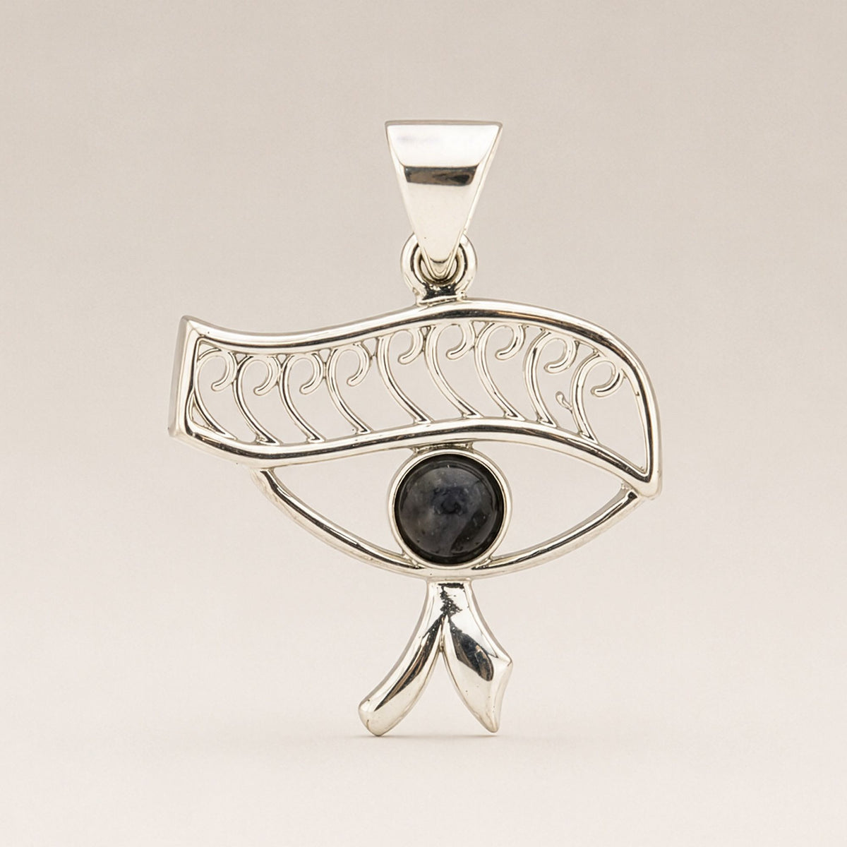 Close-up of Cleopatra Eye pendant with dark iolite stone