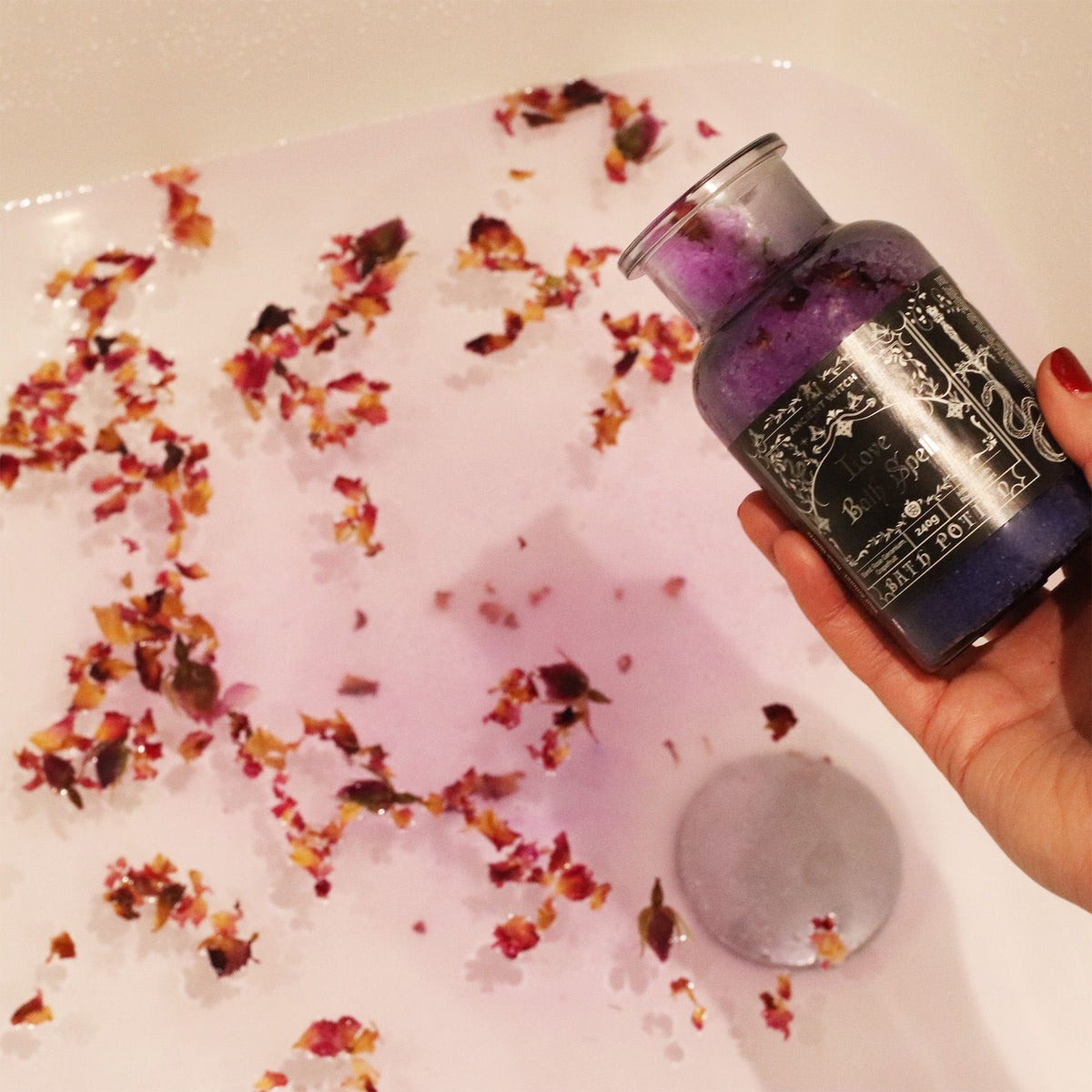 Rose petals and Love Bath Spell Potion in pink bath water