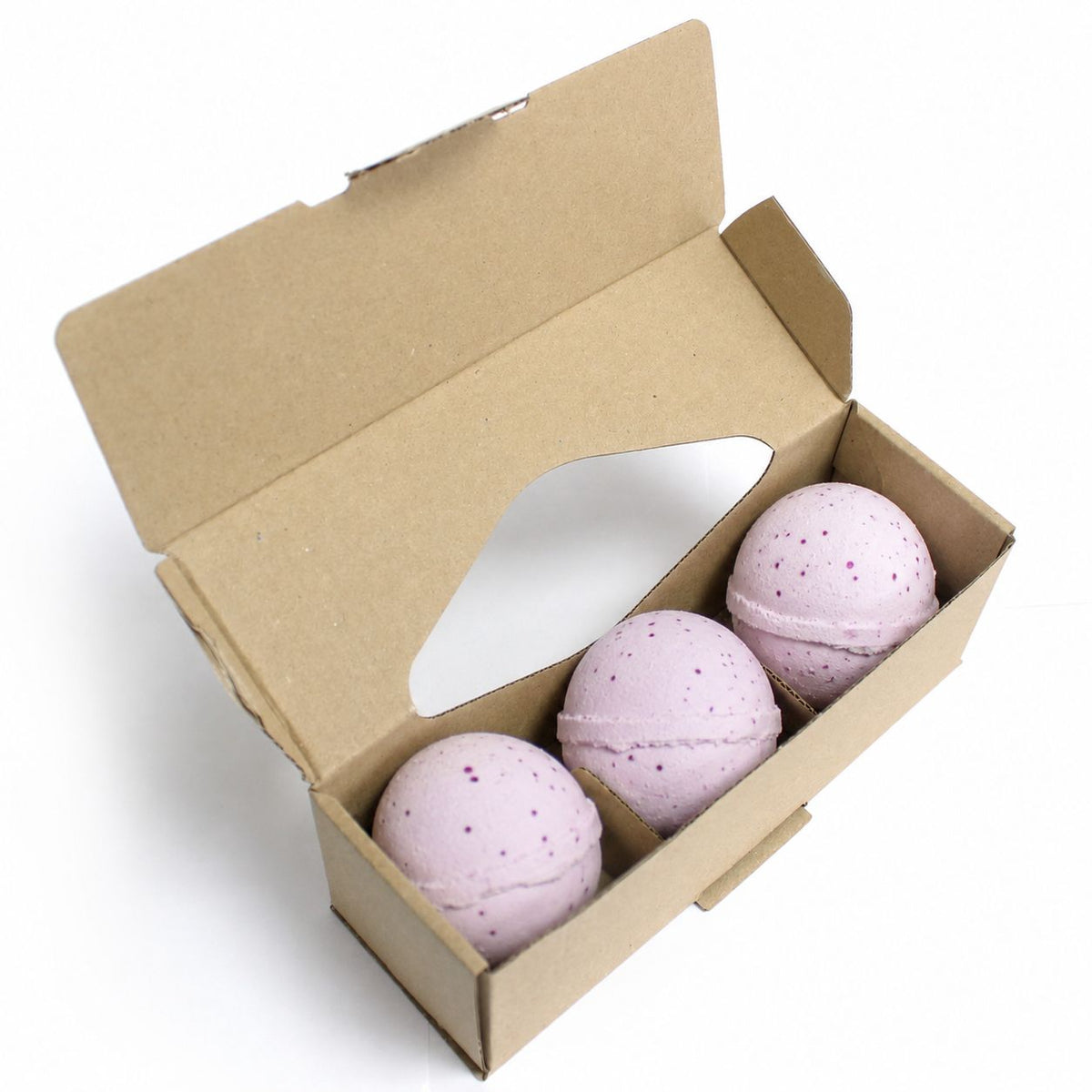 Three pink speckled Decadence bath bombs in kraft gift box