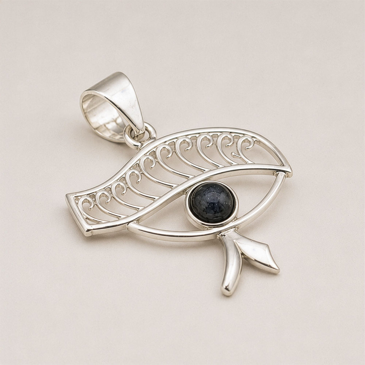 Angled close-up of silver-plated Cleopatra Eye pendant
