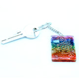 Keychain with colorful square pendant featuring a spiral design on a white background