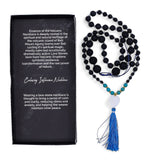 Black and blue beaded necklace with tassel next to a black card with text about the necklace.