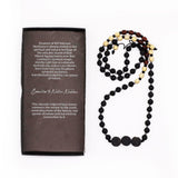 Beaded necklace with a descriptive card on a white background