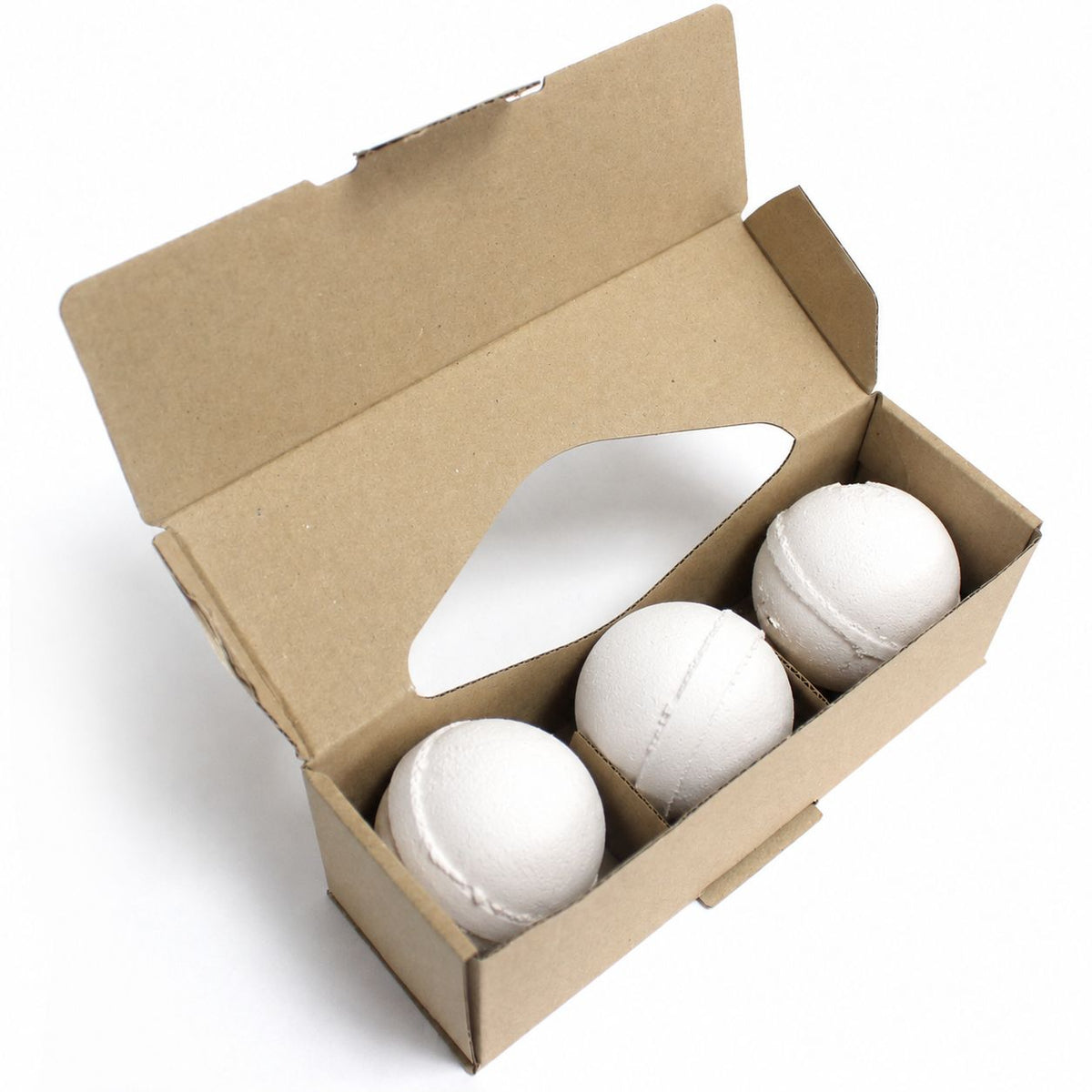 Three white aromatherapy bath bombs in kraft gift box