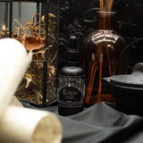 Ancient Witch Eclipse Oud perfume oil bottle in a gothic setting