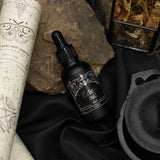 Ancient Witch Eclipse Oud perfume oil bottle and box on a witch's altar