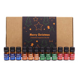 Set of Christmas fragrance oils with a decorative box in the background