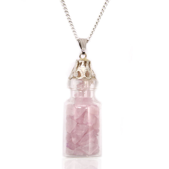 Necklace with a clear bottle pendant containing pink crystals on a white background