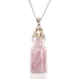 Necklace with a clear bottle pendant containing pink crystals on a white background