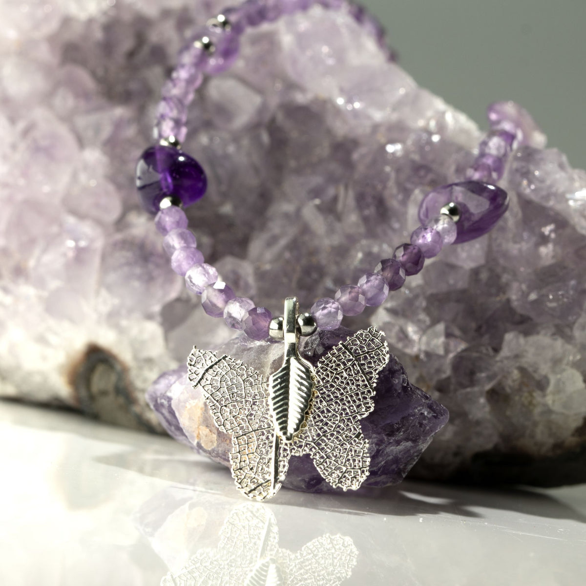 Amethyst beaded necklace with preserved leaf butterfly pendant on crystal