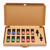 Set of fragrance oil bottles in a cardboard box on a white background