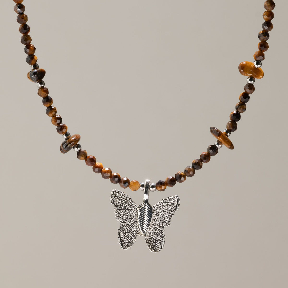 Nymph Tiger's Eye gemstone necklace with silver-plated real leaf butterfly pendant