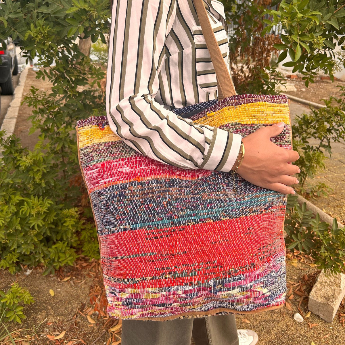 Large recycled pink rug bag being carried