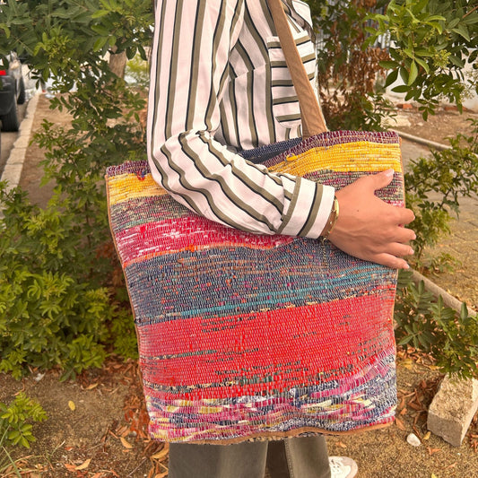 Large recycled pink rug bag being carried