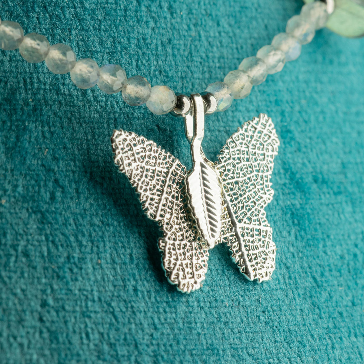 Close-up of silver-plated real leaf butterfly pendant with Labradorite gemstone beads