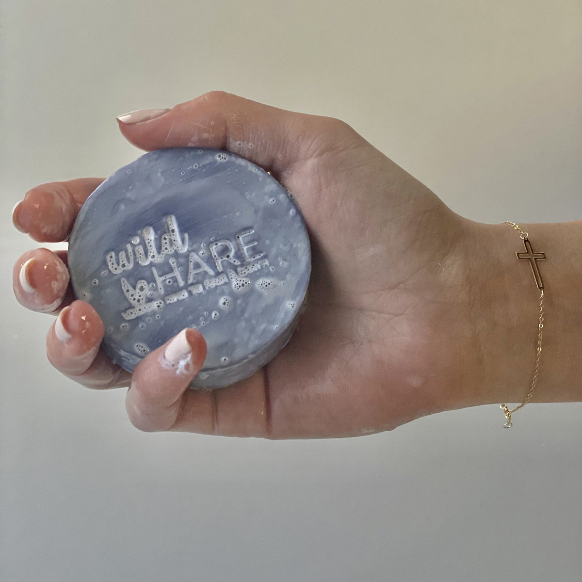 Wild Hare solid shampoo bar held in hand