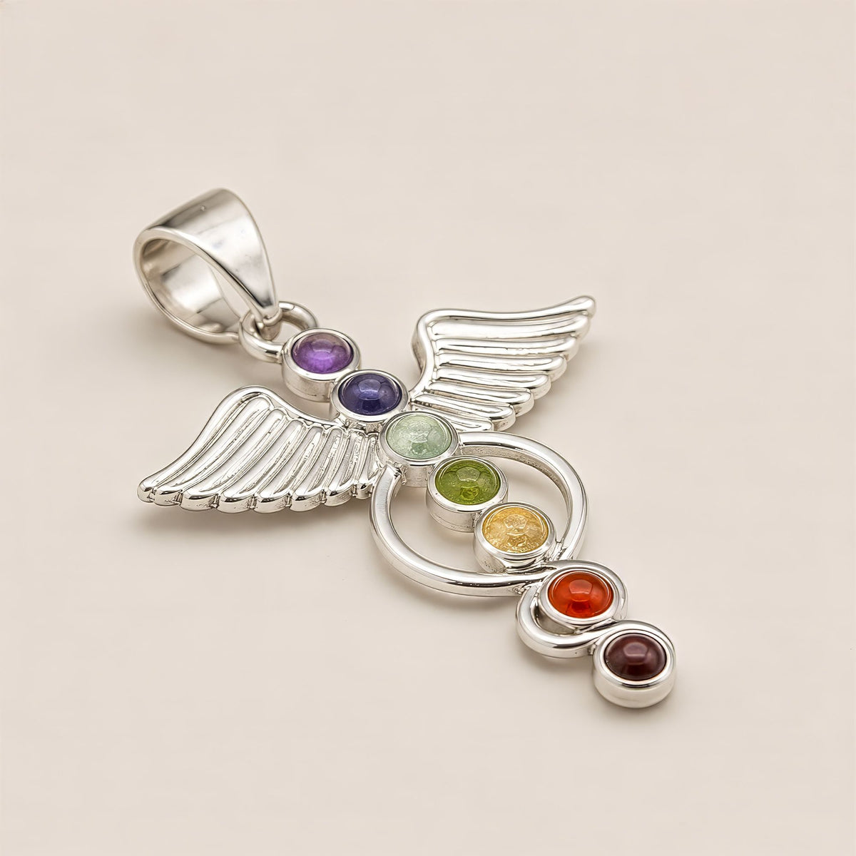 Close-up of angel chakra pendant with seven coloured stones