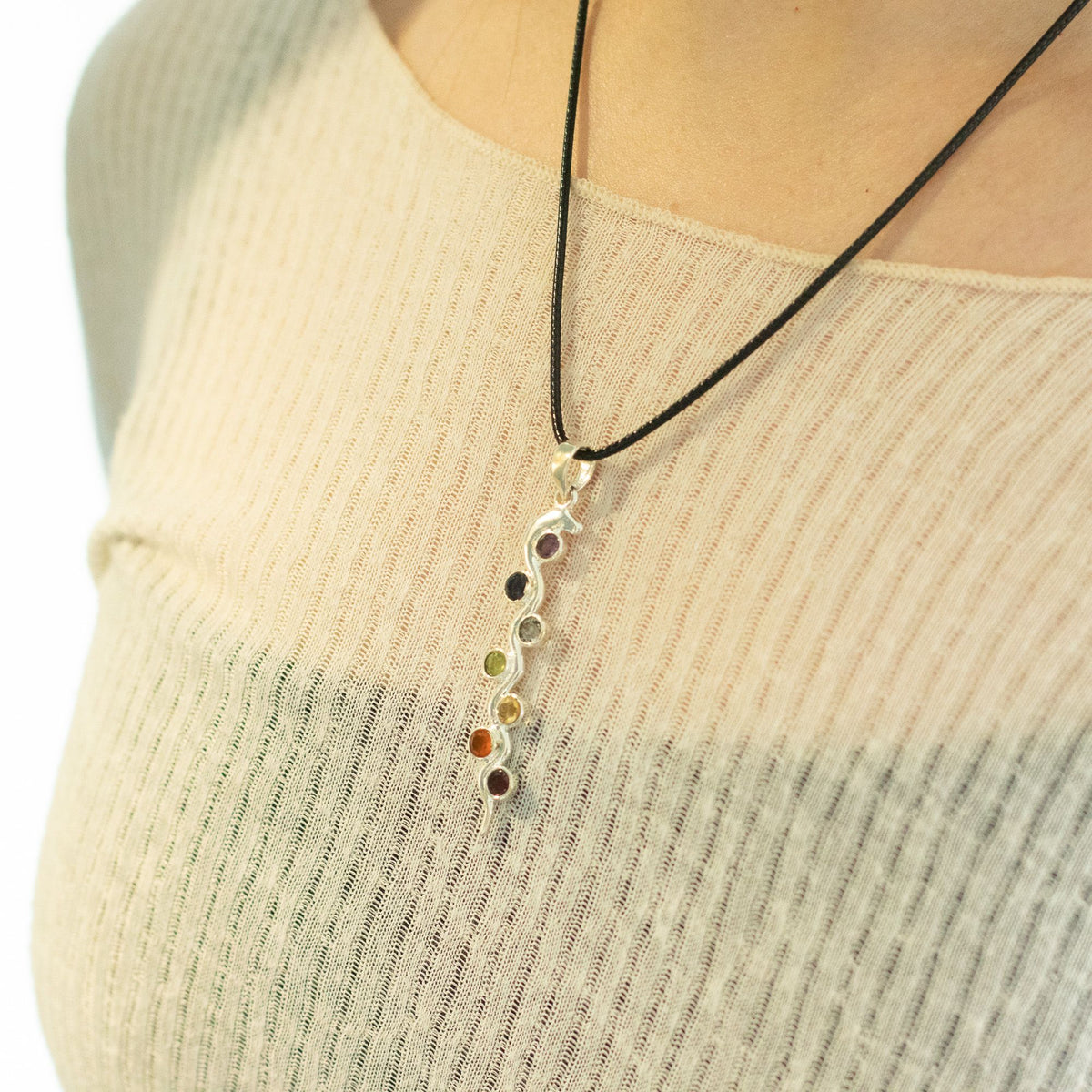 Snake chakra necklace being worn with seven coloured stones