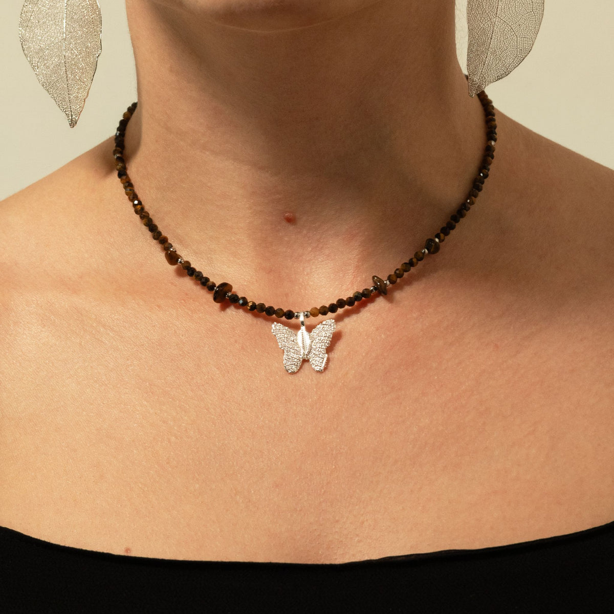 1. Nymph Tiger's Eye gemstone necklace worn around the neck