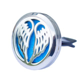 Decorative car air freshener with blue center and silver wings on a white background