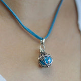 Necklace with a blue pendant on a person's neck