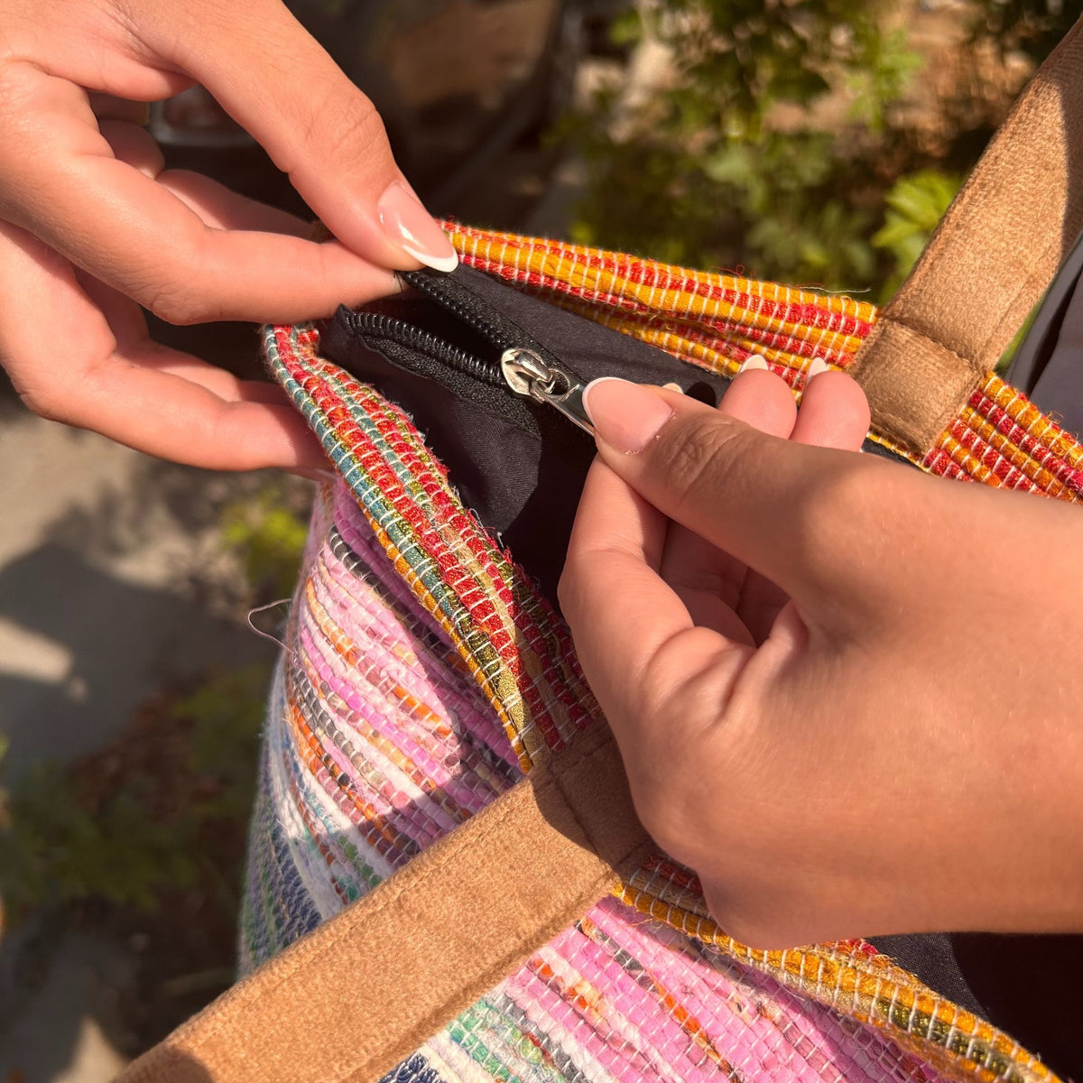 Zip closure on recycled woven rug shoulder bag