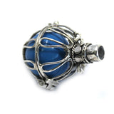 Blue glass bead with silver metal cage on a white background