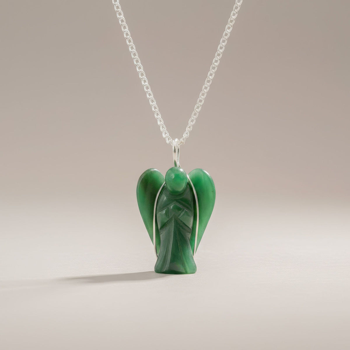 Carved Green Aventurine gemstone angel pendant close-up