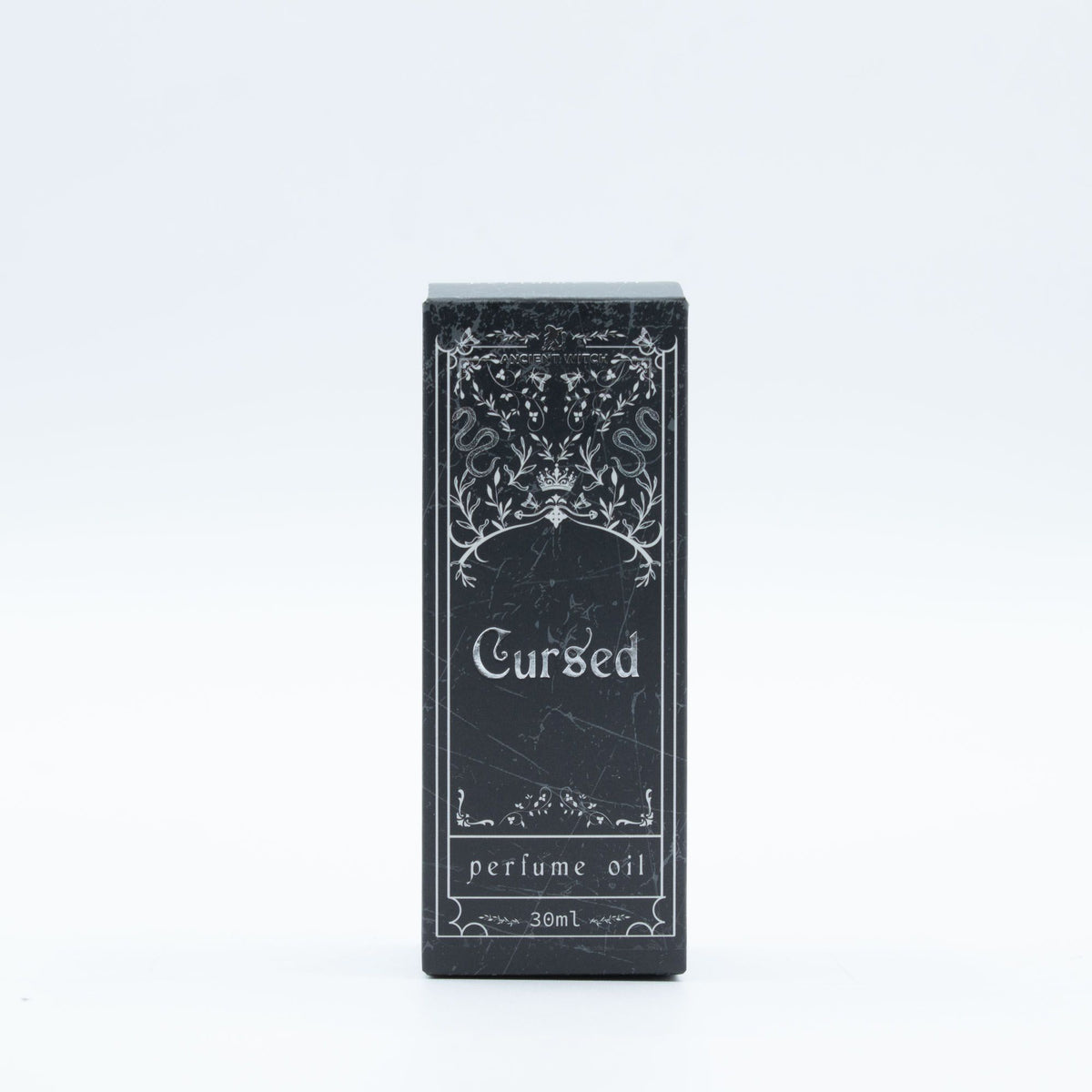 Black packaging of 'Cursed' perfume oil with decorative design on a white background