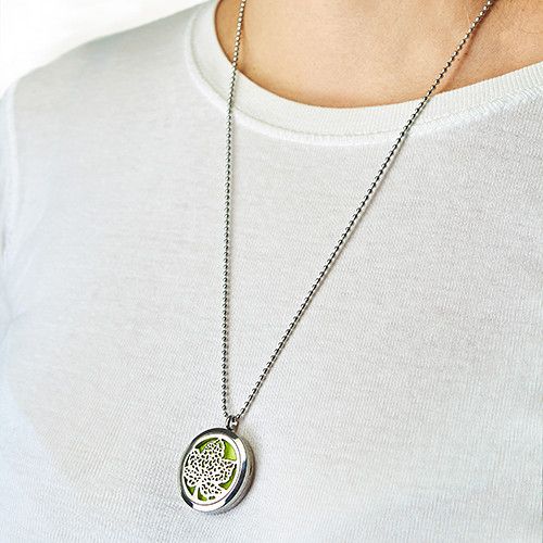 Hamsa essential oil diffuser necklace being worn