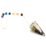 Crystal pendulum with chakra beads on a white background