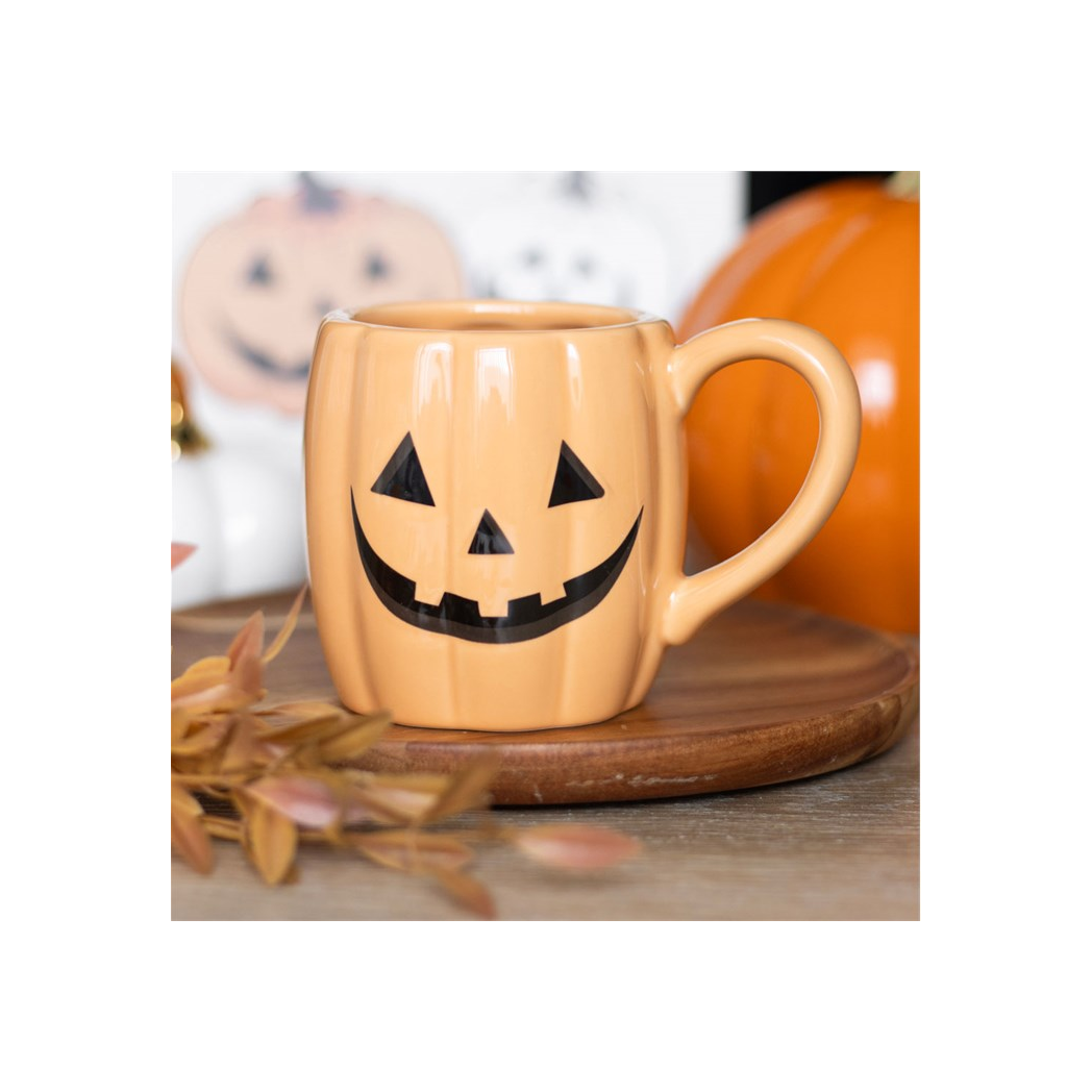 Jack-o'-lantern pumpkin shaped mug with smiling Halloween face
