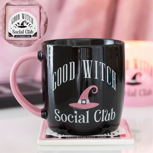 Good Witch Social Club black mug with pink handle displayed on matching coaster