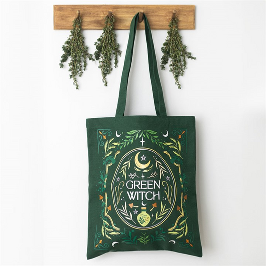 Green Witch botanical tote bag hanging with herbs