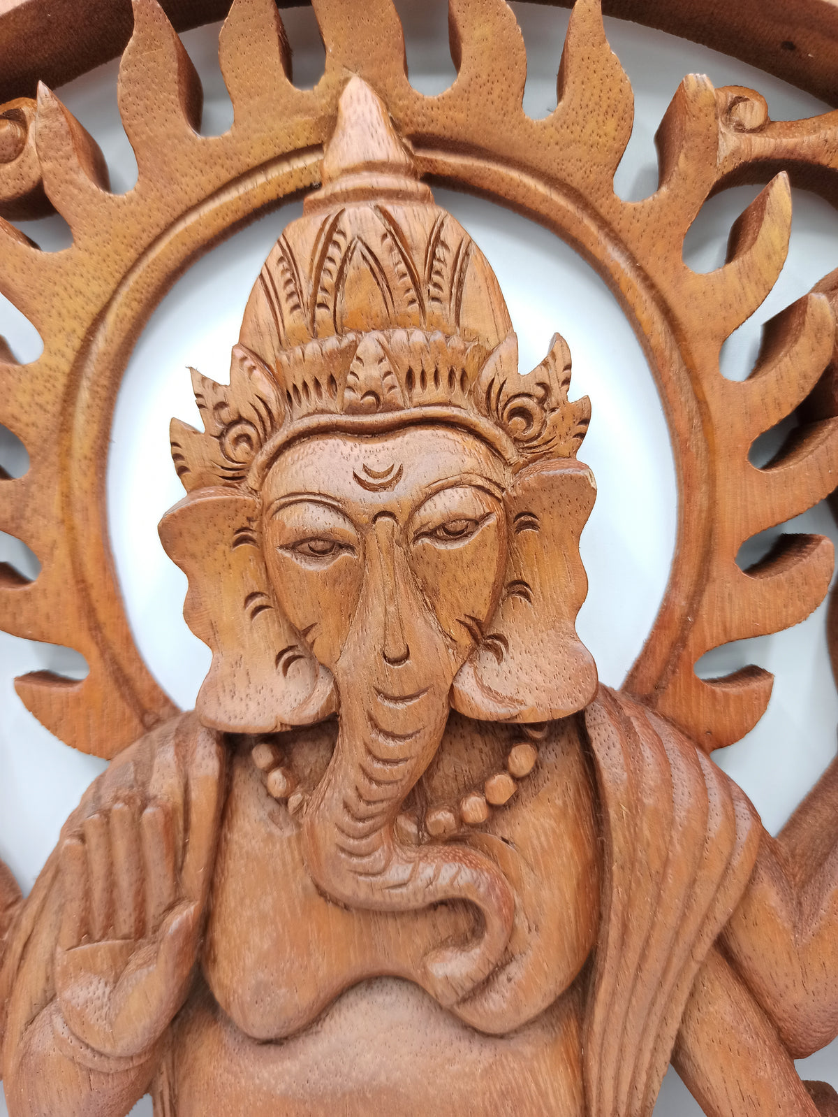 Close-up of hand carved Ganesh detail on Suar wood wall carving