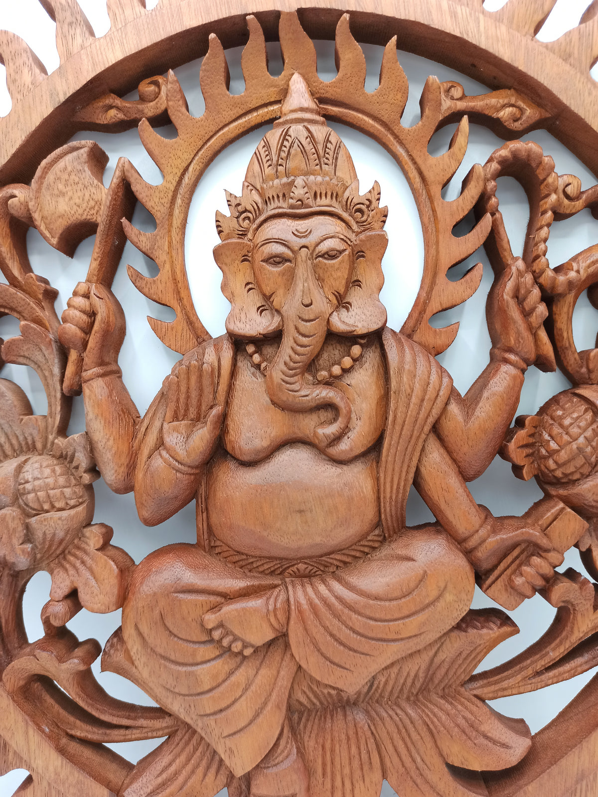 Detailed Ganesh Hindu deity carving in natural Suar wood