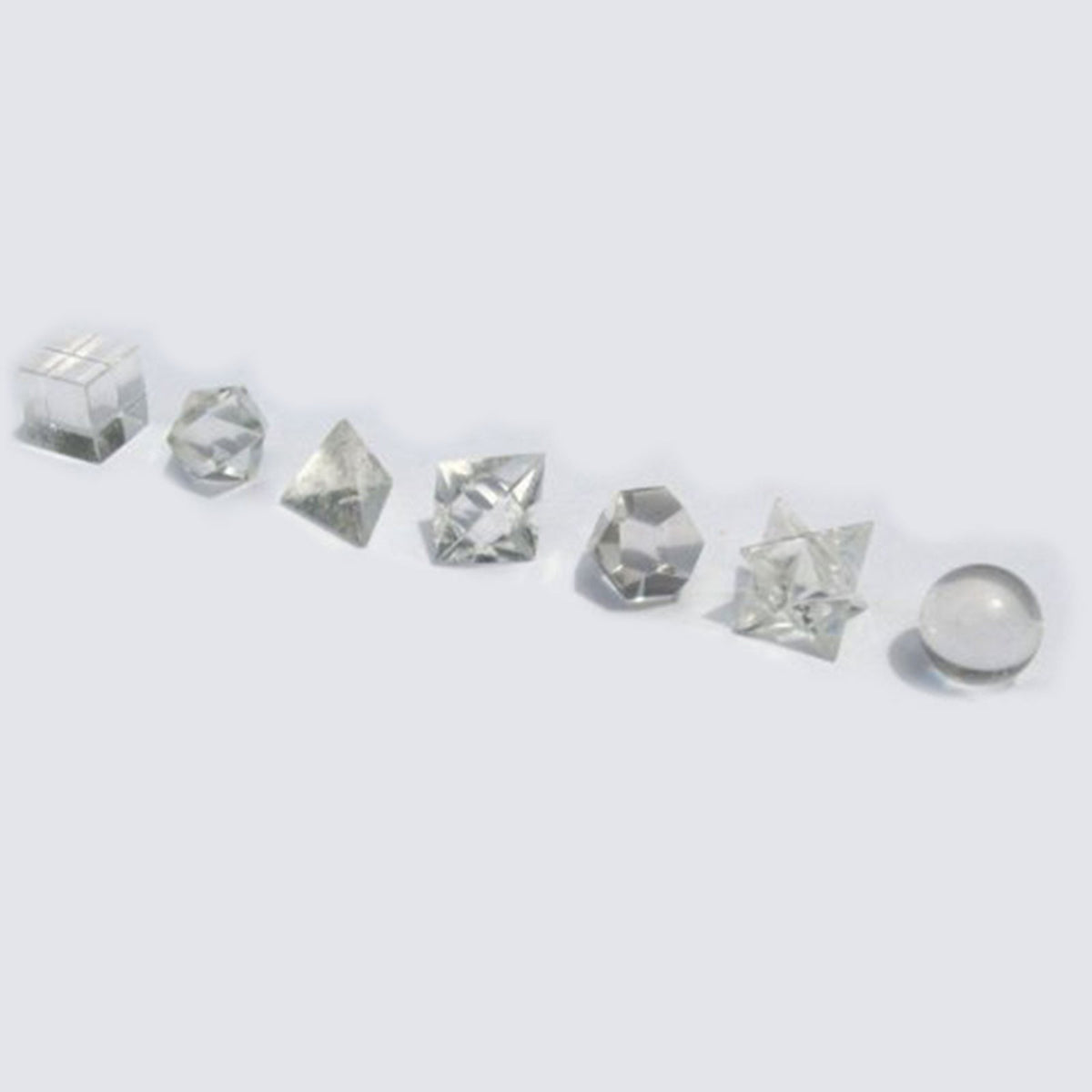 Seven clear quartz crystals in different geometric shapes